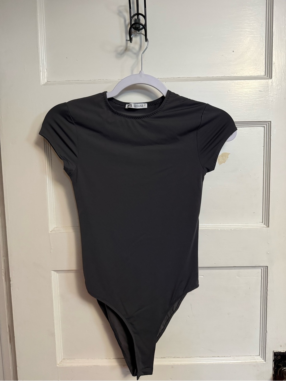 Zara black bodysuit with cap sleeves and stretchy silky smooth fabric. Size: S